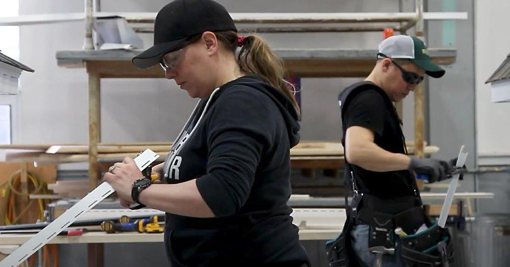 Students cutting plastic corner pieces